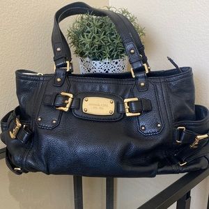 Black Michael Kors handbag with gold accents